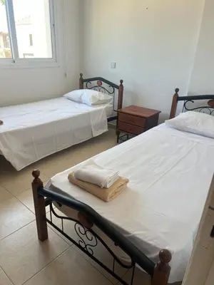 two beds in a room with two bedsskirts at Chara Cynthiana Villa in Paralimni