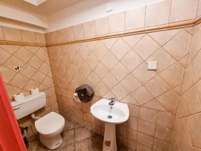 a small bathroom with a toilet and a sink at Unique City Hostel 100 meters from Beach in Larnaka