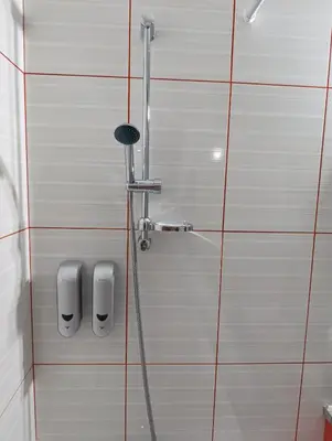 a shower with two soap dispensers on a tiled wall at Luxury Apartment No. 202 (Napa Ace) in Ayia Napa