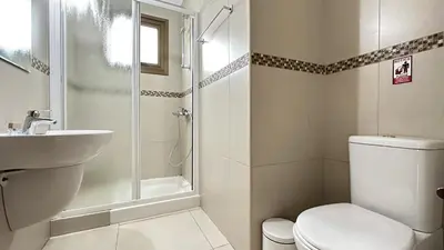 a bathroom with a shower and a toilet and a sink at Merab Holidays Villas - K13 in Ayia Napa