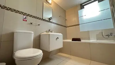 a bathroom with a toilet and a sink and a tub at Merab Holidays Villas - K13 in Ayia Napa