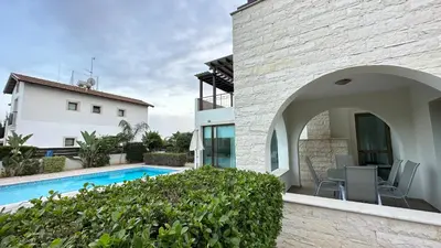 a house with a swimming pool next to a building at Merab Holidays Villas - K13 in Ayia Napa