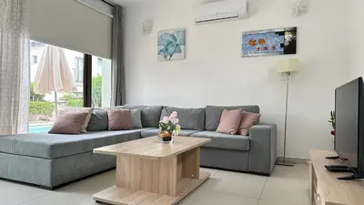 a living room with a couch and a coffee table at Merab Holidays Villas - K13 in Ayia Napa