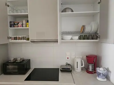 a kitchen with a black toaster and a microwave at Unique Sea & City Lifestyle Studio in Limassol