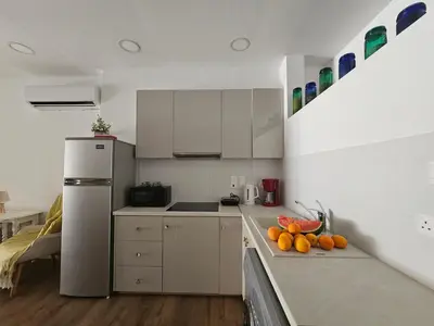 a kitchen with a refrigerator and some fruit on the counter at Unique Sea & City Lifestyle Studio in Limassol