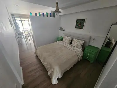 a small bedroom with a bed and a hallway at Unique Sea & City Lifestyle Studio in Limassol