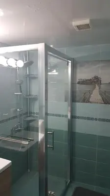 a bathroom with a shower with a glass door at Sunorama Beach Apartment in Larnaka
