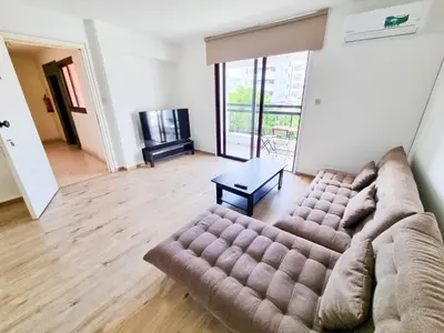 a living room with a couch and a table at Home Sweet Home Apartment in Larnaka