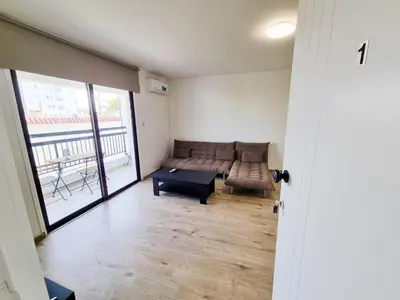 a living room with a couch and a table at Home Sweet Home Apartment in Larnaka