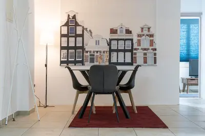 a dining room table with two chairs and a picture on the wall at Private room in shared flat in Nicosia