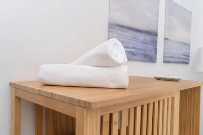 a towel sitting on top of a wooden table at Private room in shared flat in Nicosia
