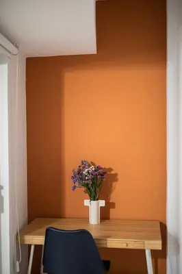 a wooden table with a vase of flowers on it at Sky-view Hideaway in Nicosia