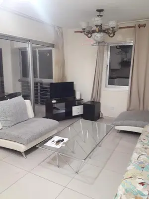 a living room with a glass table and a couch at Nicosia City Centre Apartment in Nicosia