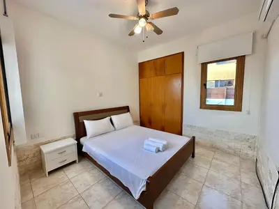 a bedroom with a bed and a ceiling fan at Lovely Pool Villa in Pyla in Pyla