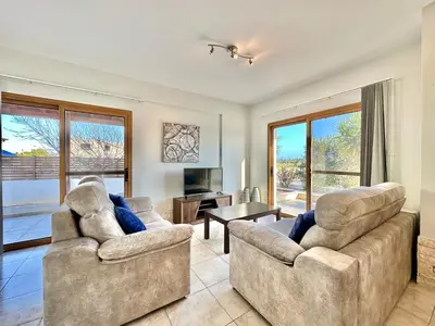 a living room with two couches and a television at Lovely Pool Villa in Pyla in Pyla