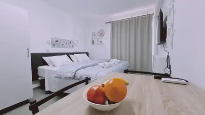a room with a table with a bowl of fruit on it at STAY Napa Living Studios in Ayia Napa