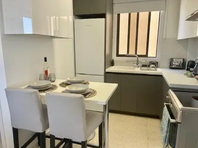 a kitchen with a table with chairs and a sink at Seaside Studio Zygi in Zygi