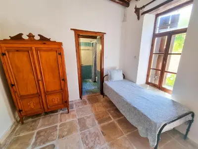 a bedroom with a bed and a dresser and a window at Athena's Pool Oasis in Skarinou