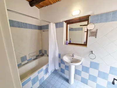 a blue and white bathroom with a sink and a tub at Athena's Pool Oasis in Skarinou