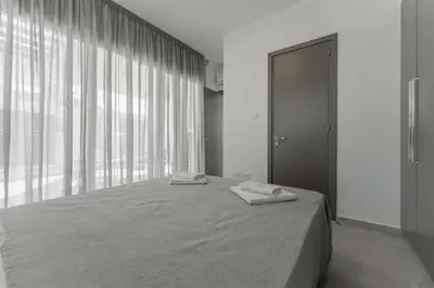 a bedroom with a bed with two towels on it at Imperial Jade V2 - Villa Semeli in Protaras in Paralimni