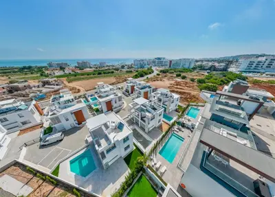 an aerial view of a building with the ocean in the background at Imperial Jade V2 - Villa Semeli in Protaras in Paralimni