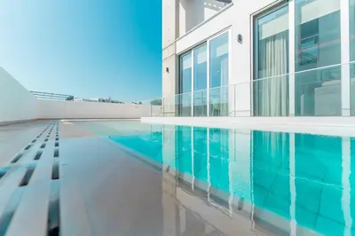 a house with a swimming pool in front of a building at Imperial Jade V2 - Villa Semeli in Protaras in Paralimni