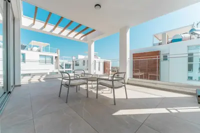 a patio with a table and chairs on a balcony at Imperial Jade V2 - Villa Semeli in Protaras in Paralimni