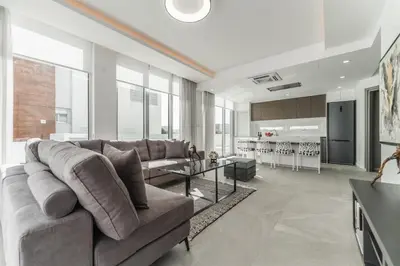 a living room with a couch and a table at Imperial Jade V2 - Villa Semeli in Protaras in Paralimni