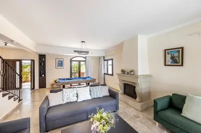 a living room with a couch and a fireplace at SunnyVillas: 4BR SeaFront Villa*Private Pool*BW44 in Protaras