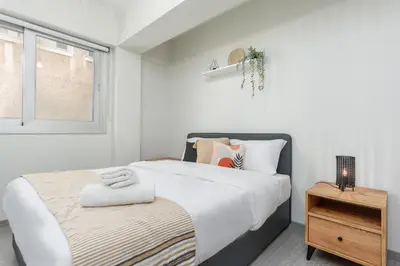 a bedroom with a large bed and a window at Amore 2-BR Apt By Finikoudes in Larnaka