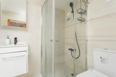 a bathroom with a shower and a toilet at Amore 2-BR Apt By Finikoudes in Larnaka