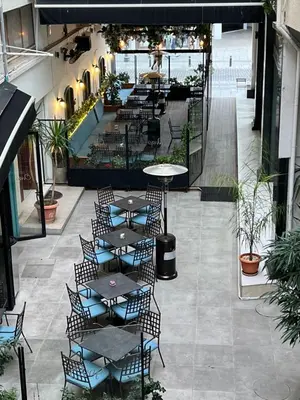 an empty patio with tables and chairs in a building at ONAR apartment in Larnaka
