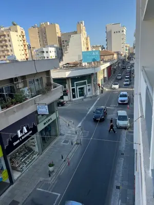 a person walking down a street in a city at ONAR apartment in Larnaka