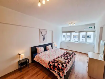 a bedroom with a bed with a floral bedspread at CityCenter Apartment in Larnaka