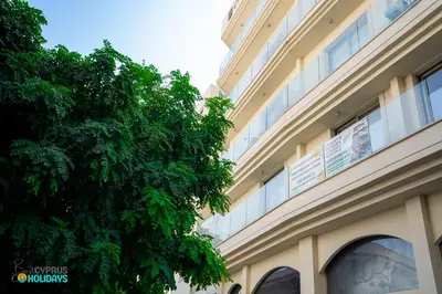 a building with a tree in front of it at Lemon Paradise City centre 200m from beach in Larnaka
