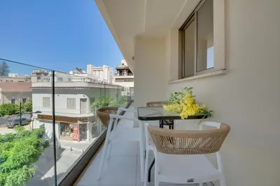 a balcony with a table and chairs and a view at Lemon Paradise City centre 200m from beach in Larnaka