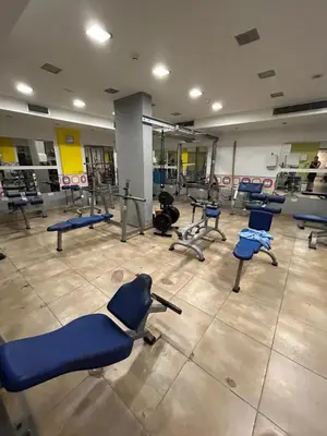 a gym with a bunch of blue chairs in a room at Paros 1 bedroom APT Kyklades in Paralimni