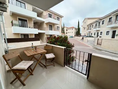 a balcony with a table and chairs on a building at Paros 1 bedroom APT Kyklades in Paralimni