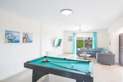 a living room with a pool table and a couch at Papaya Royal Villa in Ayia Napa