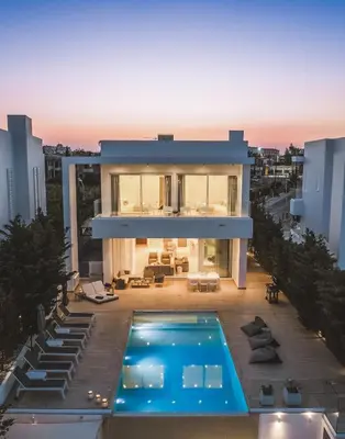 a house with a swimming pool on top of a building at Protaras Beachfront Villa Blue Waves in Protaras