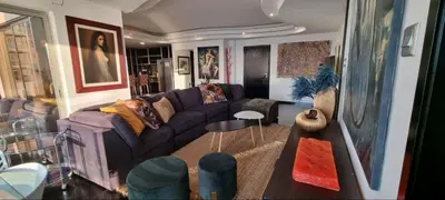 a living room with a purple couch and a table at The View Beach Penthouse in Limassol