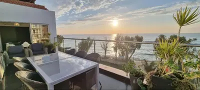 a balcony with a table and chairs and the ocean at The View Beach Penthouse in Limassol