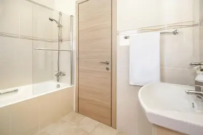 a bathroom with a shower and a sink and a tub at Villa Adonia - 30m from Pernera Beach in Protaras
