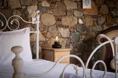 a bedroom with a bed with a candle on a table at Morfeas Kakopetria in Kakopetria