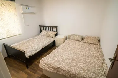 a bedroom with two beds and a window at Mezzarina apartment ayia napa in Ayia Napa