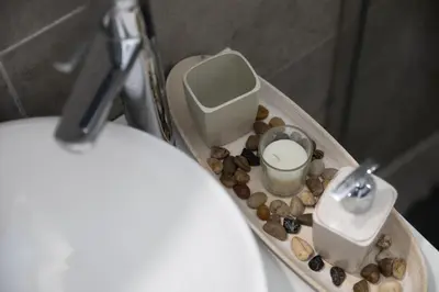 a bathroom with a toilet with a tray with rocks at Glamorous, Renovated 3-Bedroom Apt in Nicosia in Nicosia