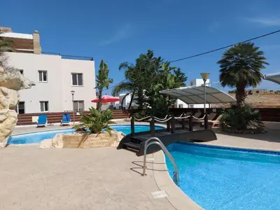 a resort with a swimming pool and a building at Pyla Palms Resorts A2 102 in Pyla