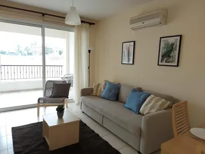 a living room with a couch and a table at Pyla Palms Resorts A2 102 in Pyla