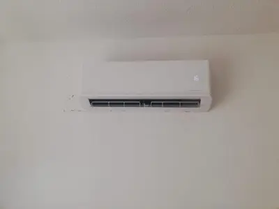a white air conditioner hanging from a ceiling at Cozy studio with terrace, sea views, near beaches and amenities in Ayia Napa