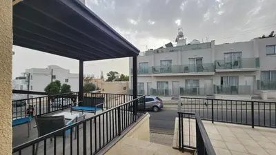 a balcony of a building with a car in a parking lot at Cozy studio with terrace, sea views, near beaches and amenities in Ayia Napa